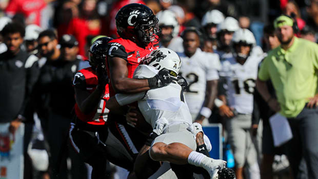 Cincinnati Bearcats linebacker Jaheim Thomas (24) stops UCF Knights quarterback Joey Gatewood (7) in the second half at Nippert Stadium.